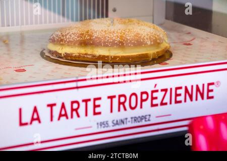 Tarte tropézienne, in a cake shop window in Cannes, France. Also known as 'La Tarte de Saint-Tropez', a dessert (brioche cream filled) pastry. (135) Stock Photo