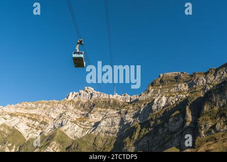 The gondola of the Saentis aerial cableway halfway in front of the impressive Saentis massif Stock Photo