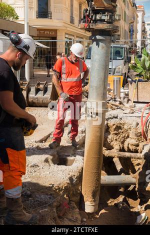 A vacuum excavator excavating a hole in the ground without damaging utilities and pipes on a road repair and construction building site. (135) Stock Photo