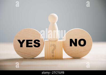 People's choice displayed on wooden blocks between right and wrong contemplating yes or no decisions Stock Photo