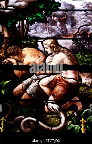 Saint Martin church.  Stained glass. Adam and Eve Driven From Paradise. Villiers sur Mer. France. Stock Photo