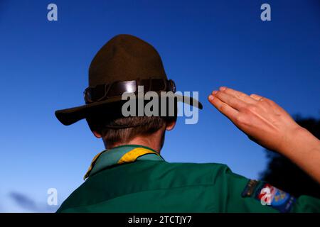 Boy scout in uniform performs three finger salute. Scout symbol hand gesture. France. Stock Photo