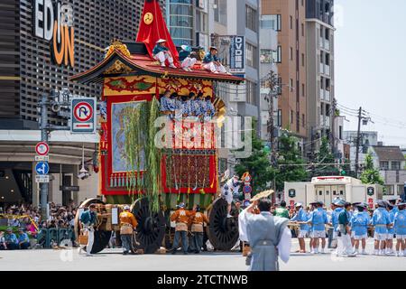 Kyoto, Japan - July 24 2023 : Gion Matsuri Festival, Yamaboko Junko Procession. People pulling the large wooden traditional float parade on the city s Stock Photo