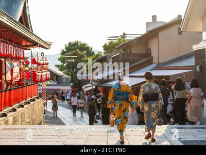 Back view two asian young women wearing Japanese traditional kimono at Fushimi Inari Shrine during the Motomiya Matsuri Festival. Kyoto, Japan. Stock Photo