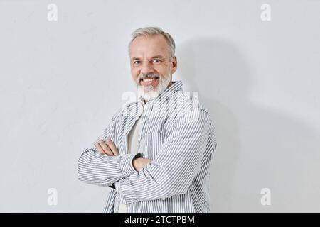 Happy Aged Man Crossing Hands Smiling at Camera Stock Photo