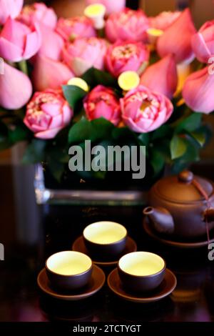 Three cups of tea and lotus flowers. Tea ceremony. Stock Photo
