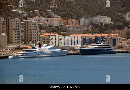 Two Expensive Luxury Super Yachts Moored up by a Private Jetty in Gibraltar, BOT, Spain, EU. Stock Photo