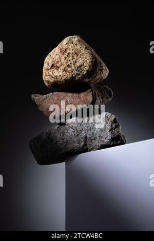Stacked natural stones on a white box Stock Photo