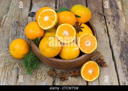 fresh tangerines in a bowl on old wooden background Stock Photo