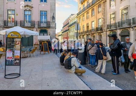 A long line of people waiting to purchase bifana sandwiches at the popular As Bifanas do Afonso shop in Lisbon Portugal. Stock Photo