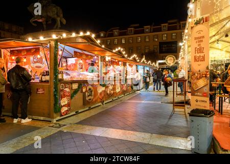 Evening view of holiday decorations and food booths at the Rossio Christmas Market in the Baixa district of Lisbon, Portugal. Stock Photo