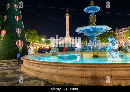 Evening view of holiday decorations and food booths at the Rossio Christmas Market in the Baixa district of Lisbon, Portugal. Stock Photo