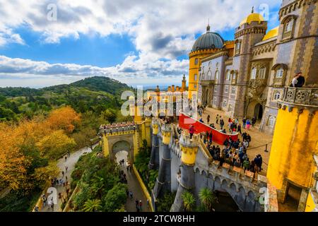 Tourists crowd the colorful levels and platforms at the National Palace of Pena, a Romanticist castle in São Pedro de Penaferrim, in Sintra, Portugal. Stock Photo