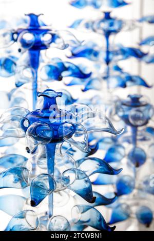 Abstract glass installation, blue decoration objects over white background, vertical photo Stock Photo