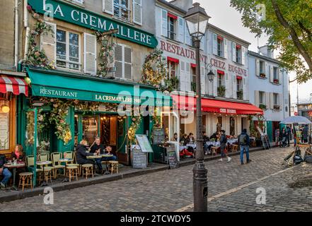 People sitting outside La Crémaillère 1900 in the late afternoon on a winters day in Place du Tertre , Montmartre,Paris, France Stock Photo