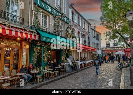 People sitting outside La Crémaillère 1900 in the late afternoon on a winters day in Place du Tertre , Montmartre,Paris, France Stock Photo