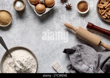 various baking ingredients on light grey painted kitchen table background, top view Stock Photo