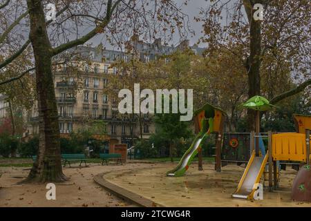 Paris, France, 2023. The deserted playground Square Henri Galli, Boulevard Henri IV, on a very rainy day in autumn Stock Photo