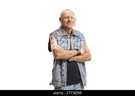 Bald rocker man in a denim vest posing and gesturing rock and roll sign ...