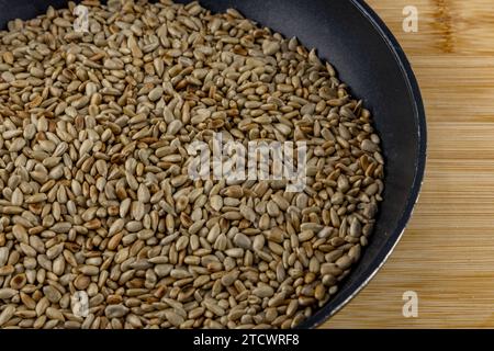 Roasted sunflower seeds in a pan, ingredients for the cake Stock Photo