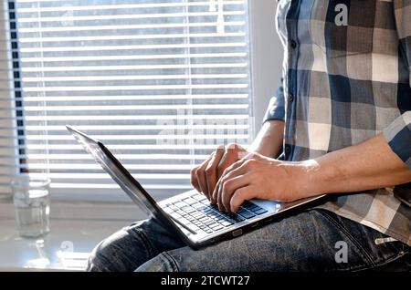 A freelancer works in a home office. Programmer. Laptop Stock Photo