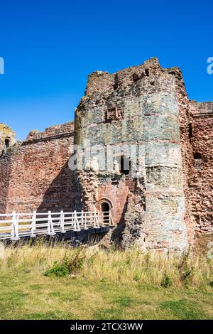 The Barbican and red sandstone Curtin Wall of Tantallon Castle, a ruined mid-14th-century fortress, in East Lothian, Scotland, UK Stock Photo