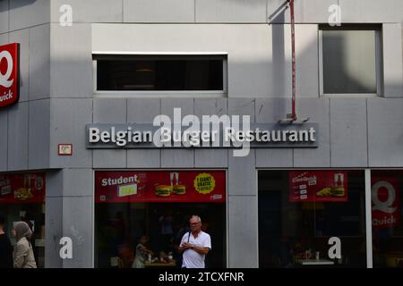 Large text 'Belgian Burger Restaurant' on the building exterior that houses the Belgian fast food chain 'Quick' in the city centre of Antwerp Stock Photo