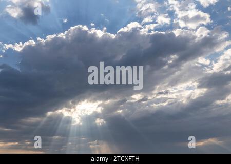 Sunrays breaking through morning clouds Stock Photo
