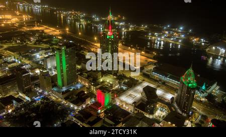 Aerial view of the downtown Mobile, Alabama waterfront skyline illuminated with Christmas colors at night Stock Photo