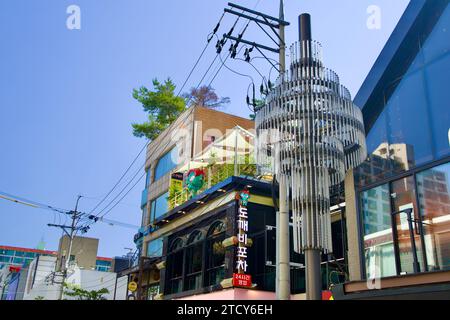 Seoul, South Korea - June 2, 2023: Underneath the elegant chandelier streetlights of Apgujeong Rodeo Street, with a glimpse of fashionable storefronts Stock Photo