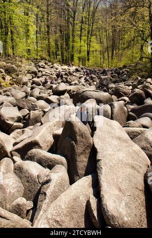 Lautertal, Germany - April 24, 2021: Giant rocks covering a hill at Felsenmeer on a spring day in Germany. Stock Photo