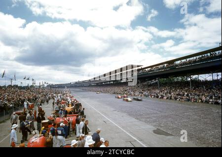 INDIANAPOLIS, IN - MAY, 1955:  General view as cars race around the track during the Indianapolis 500 circa May, 1955 at the Indianapolis Motor Speedway in Indianapolis, Indiana.  (Photo by Hy Peskin) Stock Photo