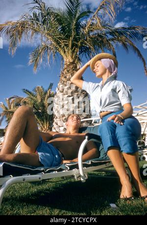 LAS VEGAS, NV - 1958: Actress and model Kitty Dolan sits at the pool with a friend circa 1958 at The Tropicana Hotel in Las Vegas, Nevada. (Photo by Hy Peskin)  *** Local Caption *** Kitty Dolan Stock Photo