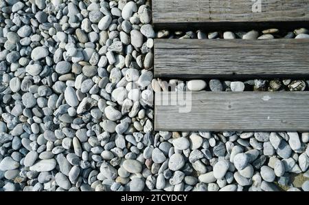 Small stones in various shades of gray.decorative pebbles.Decorative stones around the railway sleepers. Stock Photo