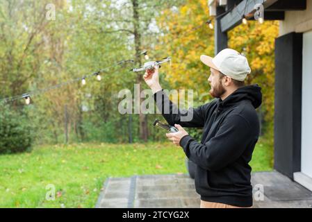 Young Man playing with drone outdoors Stock Photo