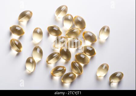 Soft gel capsules, randomly arranged, from above. Oral dosage medicine or dietary supplement in the form of a transparent capsule. Stock Photo