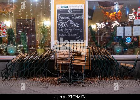 Stühle und Tische stehen zusammengestellt vor einem indischen Restauren auf der Prenzlauer Allee in Berlin. / Chairs and tables are arranged in front of an Indian restaurant on Prenzlauer Allee in Berlin. Indisches Restaurant *** Chairs and tables are arranged in front of an Indian restaurant on Prenzlauer Allee in Berlin Chairs and tables are arranged in front of an Indian restaurant on Prenzlauer Allee in Berlin Indian restaurant snph202312142067.jpg Stock Photo