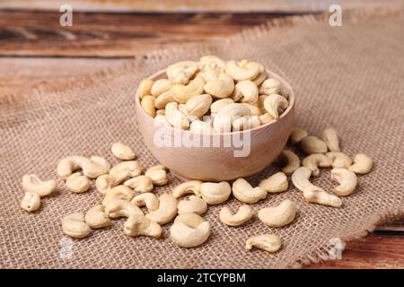 Tasty cashew nuts in bowl on a old wooden table Stock Photo - Alamy