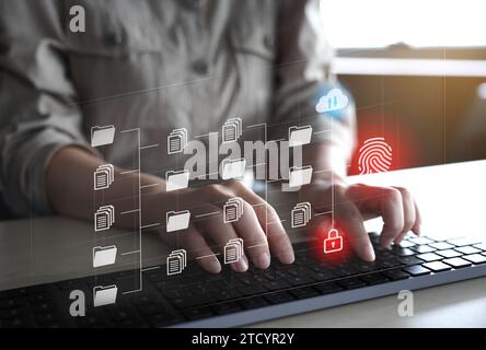 Female hands typing on keyboard and virtual hologram screen symbolizing security Stock Photo