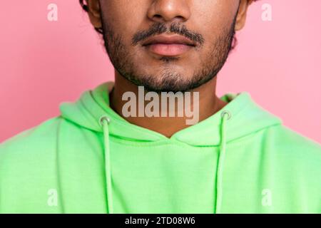 Closeup cropped photo of confident young indian man wear green sweatshirt unshaven model for barbershop isolated on pink color background Stock Photo