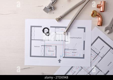 Engineering and development in installations and reforms of water in houses with diagrams and plans on an office table and various material elements. Stock Photo