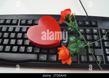 red heart and red roses with computer keyboard, symbolic image of love ...