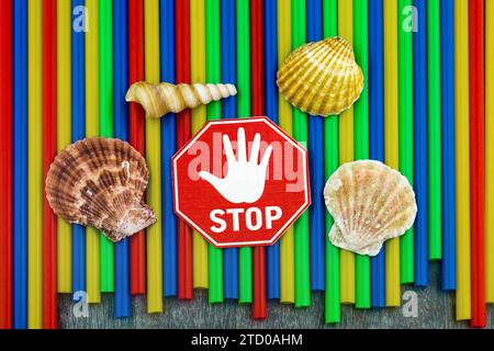 Plastic straws with stop sign, shells and snail shells from the sea, ban on plastic, marine littering Stock Photo