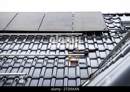 Installation in Progress of Solar Panels on a Residential Rooftop Stock Photo