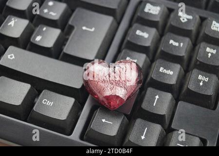 red heart on a computer keyboard, love online Stock Photo
