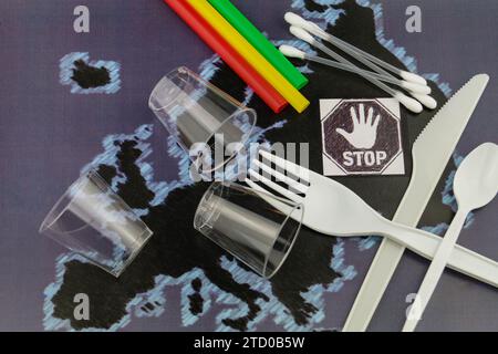 Plastic cutlery, cups and straws on a map of Europe with stop sign, ban on plastic in the EU Stock Photo