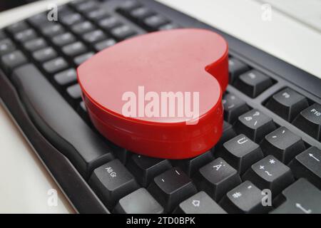 red heart on a computer keyboard, love online Stock Photo