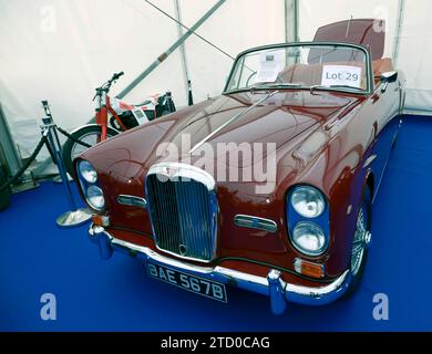 Three-quarters front view of a Maroon, 1964, Alvis TE21 Cabriolet, in the Ewbanks Live auction, at the 2023 British Motor Show Stock Photo