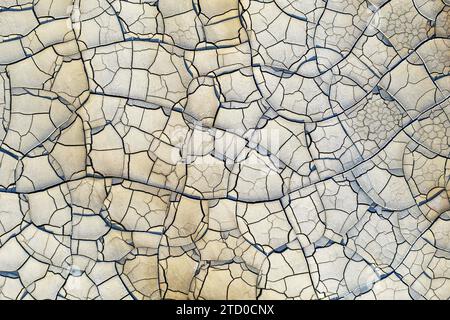 Overhead view of cracked soil in Riotinto, reflecting a natural arid landscape texture with distinct parched patterns. Stock Photo