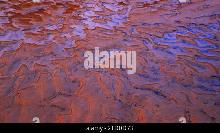 Stunning natural sand formations create a mesmerizing pattern on the Occidental Coast of Asturias, Spain. Stock Photo